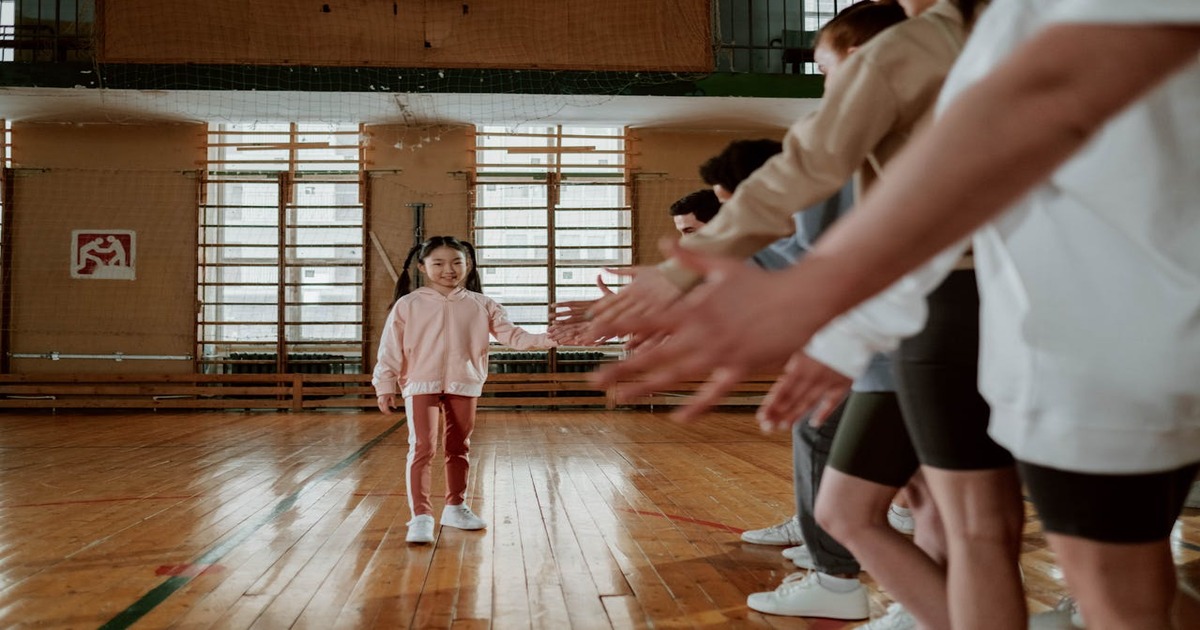 Kids playing basketball and soccer on an indoor multi-sport court during a holiday program.