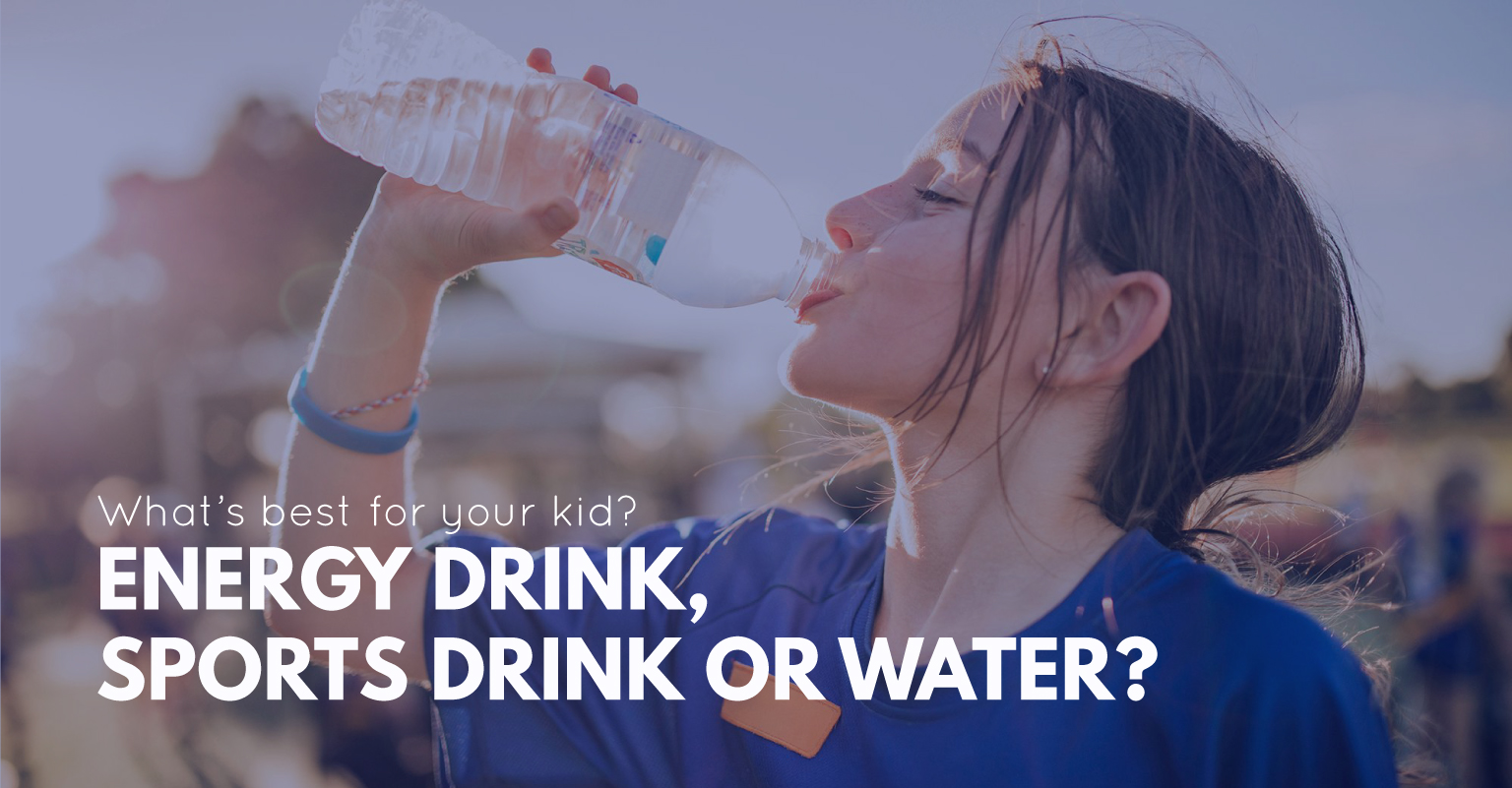 A young girl in sports gear taking a refreshing drink of water from a reusable bottle.