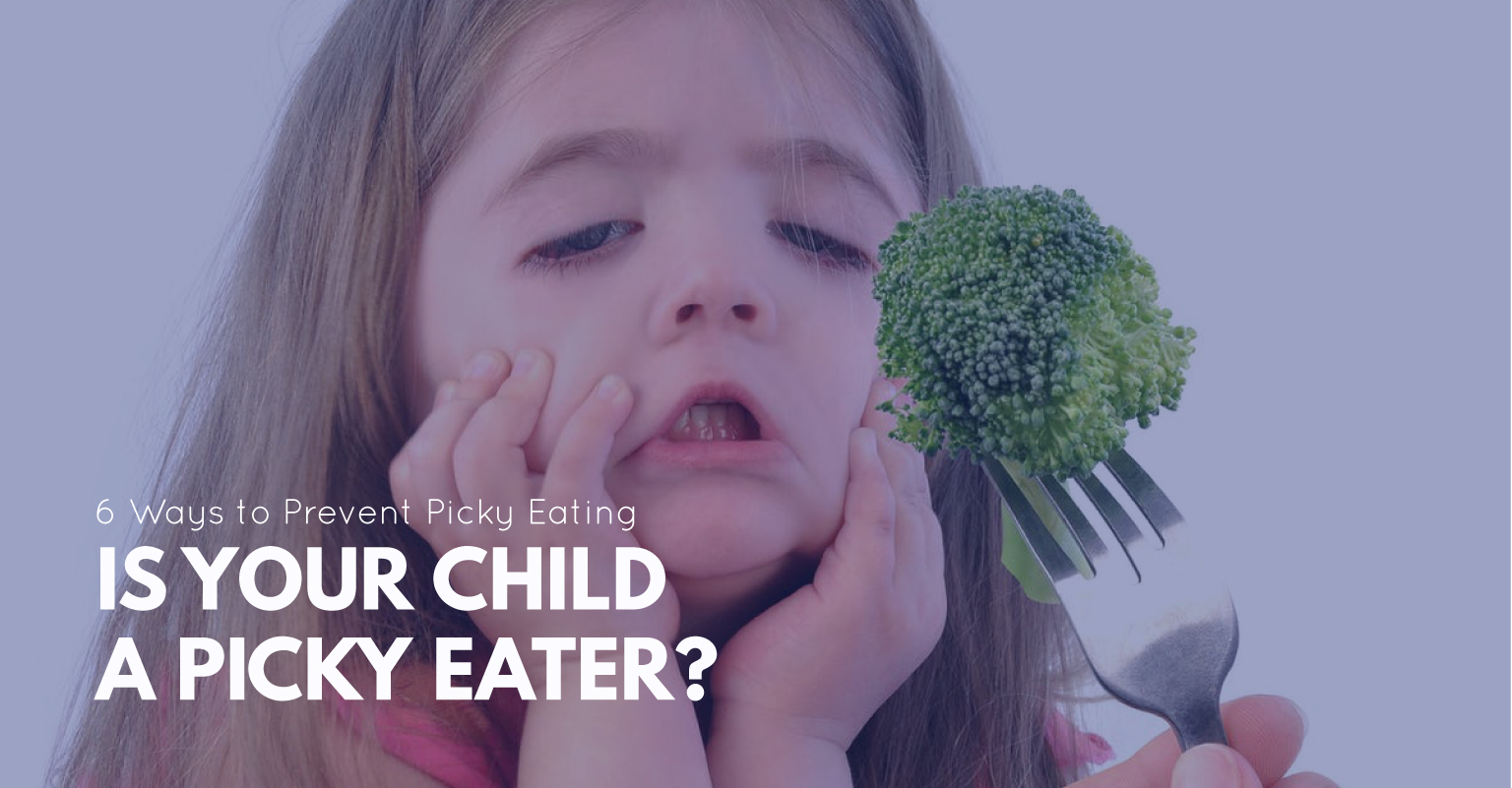 Child smiling while eating a bright green apple and fresh vegetable sticks.
