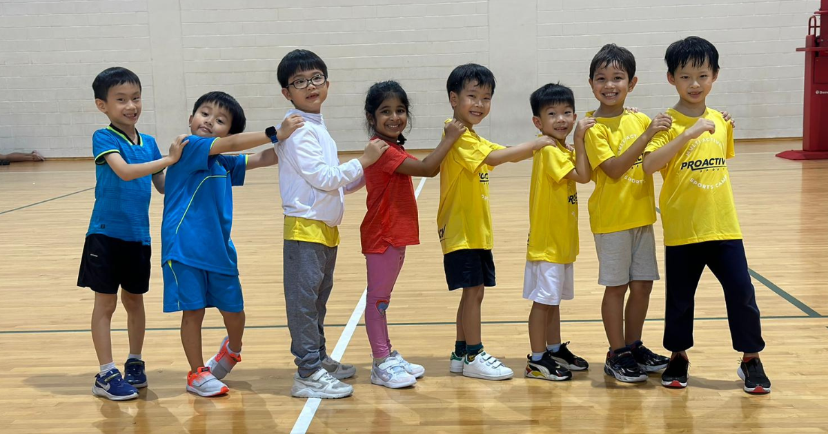 Happy family with young children jogging together along a scenic Singapore park path during school holidays.